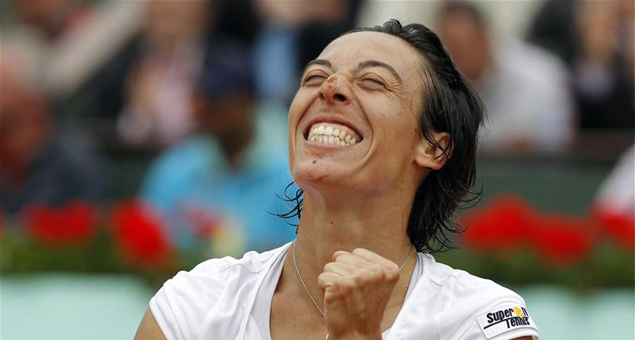 Francesca Schiavone reacts after defeating Caroline Wozniacki